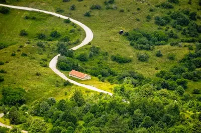 an overhead view of a road and a house on a hill at Apartment Vidus Wine Estate in Podnanos