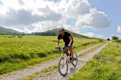 a man riding a bike on a dirt road at Apartment Vidus Wine Estate in Podnanos