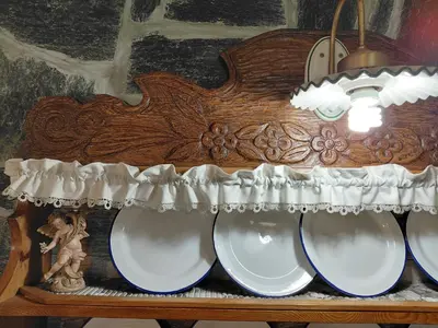 a wooden shelf with white dishes and a lamp at Apartma Alpski vrt in Vojsko