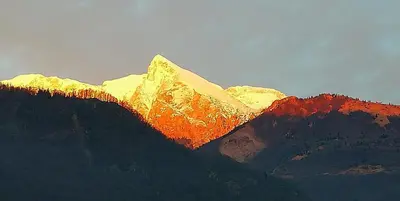 a group of mountains with the sun shining on them at HišaŠmihelka in Kobarid