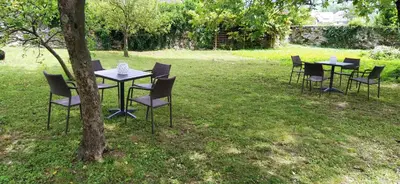 a group of tables and chairs sitting in the grass at Soca treasure with free parking in Bovec