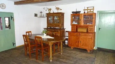 a dining room with a table and a cabinet at Homestay Kapl in Ledinek