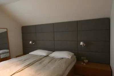 a bedroom with a large bed with two pillows at Village House in Železniki