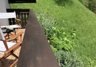 a wooden table and a chair in a garden at Village House in Železniki