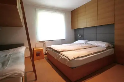 a bedroom with a large bed and a window at Village House in Železniki