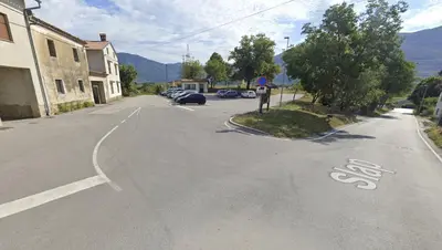 an empty street in a small town with a bike lane at Boutique Rooms & Winery Žorž in Vipava
