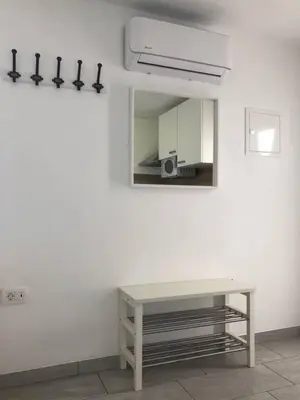 a white room with a table and a mirror at Jack's Apartments in Bled