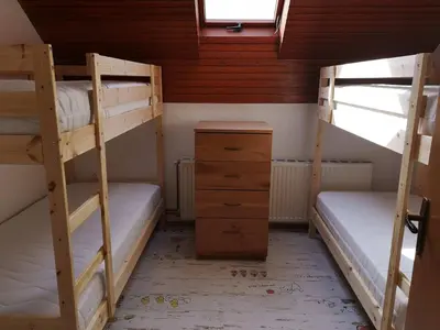 a bedroom with two bunk beds and a dresser at Sobe SM0LEJ in Bled