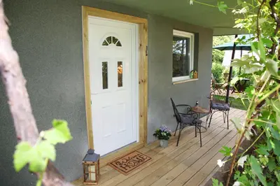 a front door of a house with a table and chairs at STUDIO LUNA in Bled