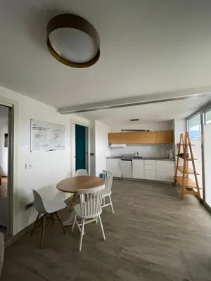a kitchen and dining room with a table and chairs at Mr and Mrs Bright 5 in Ljubljana