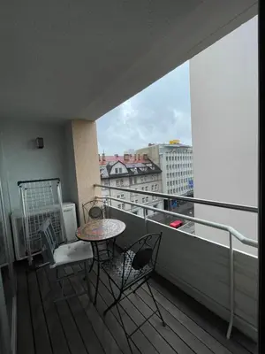 a balcony with a table and chairs and a view of a city at Mr and Mrs Bright 5 in Ljubljana