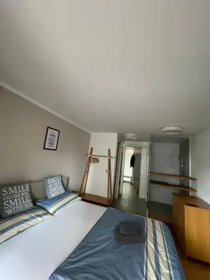 a bedroom with a large bed and a dresser at Mr and Mrs Bright 5 in Ljubljana