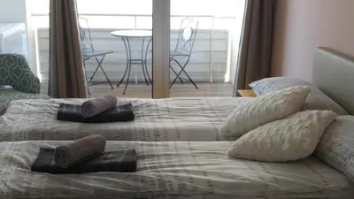 a bed with pillows on it in a bedroom at Mr and Mrs Bright 5 in Ljubljana
