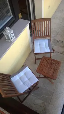 a chair and a bench sitting on a porch at Apartma Arnež in Bled