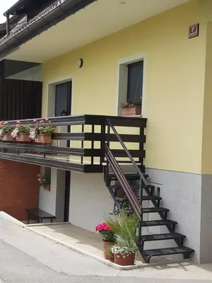a staircase on the side of a building with potted plants at Apartma Arnež in Bled