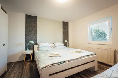 a bedroom with a bed with two towels on it at Apartma Arnež in Bled