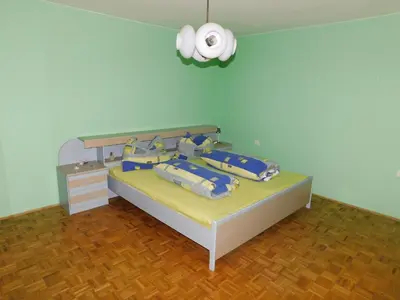 a bedroom with a bed with blue sheets and blue pillows at Haus Videm in Videm pri Ptuju