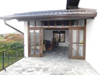 an open patio with a roof and glass doors at Haus Videm in Videm pri Ptuju