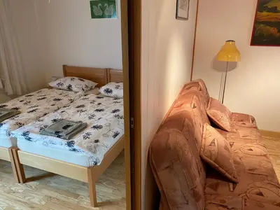 a bedroom with a bed and a mirror at Apartma Leban Most na Soči in Most na Soči