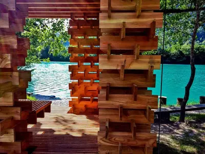 a wooden wall with a view of a lake at Apartma Leban Most na Soči in Most na Soči