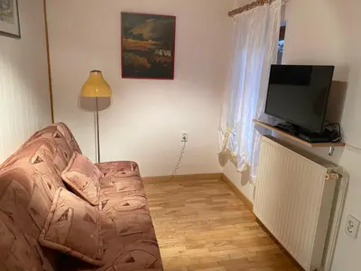 a living room with a couch and a flat screen tv at Apartma Leban Most na Soči in Most na Soči