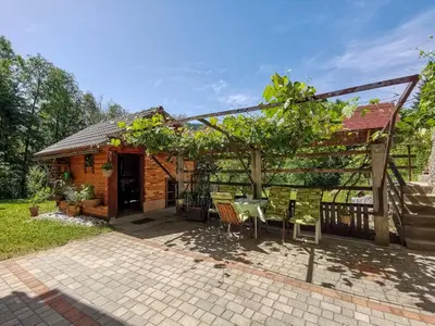 a patio with a table and chairs and a pergola at Apartment Life in Bled