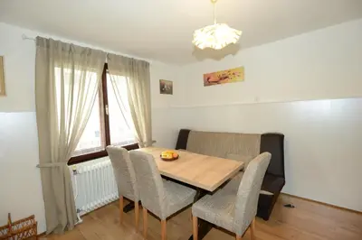 a dining room with a wooden table and chairs at Brane & Jaka Apartments in Bohinj