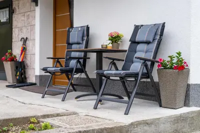 two chairs and a table on a patio at Brane & Jaka Apartments in Bohinj