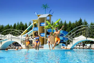 a group of people jumping in the water at a water park at Honey Paradise glamping resort in Dobova