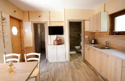a kitchen with a table and a sink and a tv at Honey Paradise glamping resort in Dobova