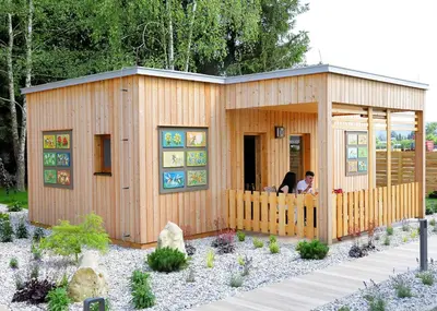 a small wooden building with two people sitting in it at Honey Paradise glamping resort in Dobova
