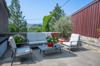 a patio with a couch and two chairs and a table at Suites DANICA in Šmartno
