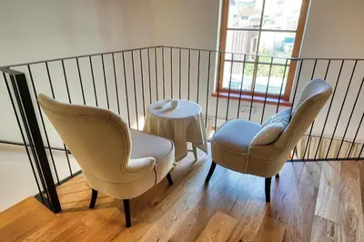 two chairs and a table in a room at Suites DANICA in Šmartno