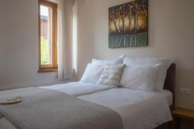 a bed with white sheets and pillows in a bedroom at Suites DANICA in Šmartno
