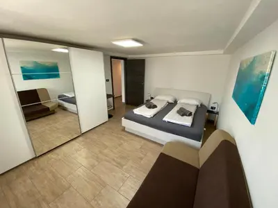 a bedroom with a bed and a large mirror at Castle View in Tolmin