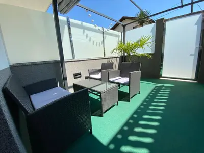 a balcony with chairs and tables on a roof at Castle View in Tolmin