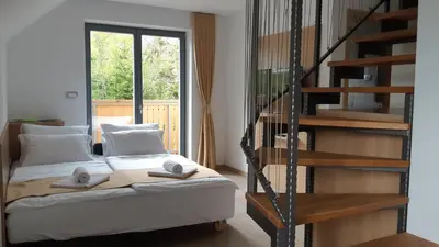 a bedroom with a bed with two towels on it at Apartments Vila Darja in Bohinj