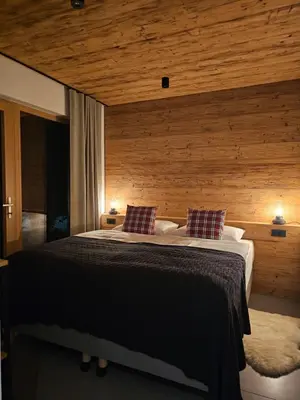 a bedroom with a large bed with two pillows at Apartmaji štAla in Kranjska Gora