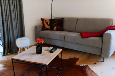 a living room with a couch and a coffee table at Apartmaji štAla in Kranjska Gora