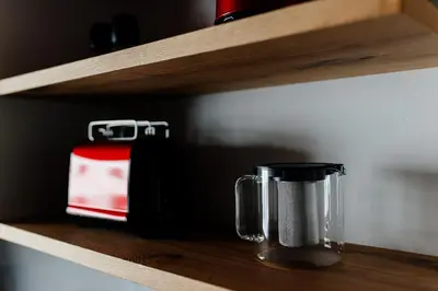 a shelf with two coffee cups on it at Apartmaji štAla in Kranjska Gora