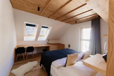 a bedroom with a bed and a desk in it at Apartmaji štAla in Kranjska Gora