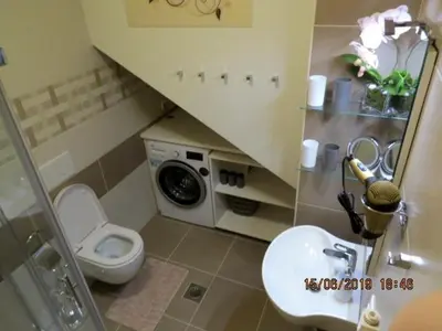 a small bathroom with a toilet and a sink at Sunlight Apartment in Bled