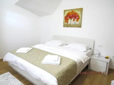 a bedroom with a bed with two towels on it at Sunlight Apartment in Bled