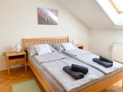 a bedroom with a large bed with two pillows on it at Ela's Apartment in Komenda