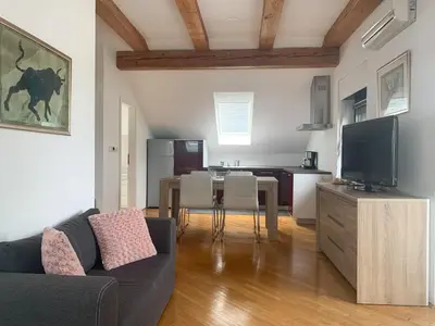 a living room with a couch and a table with a tv at Ela's Apartment in Komenda