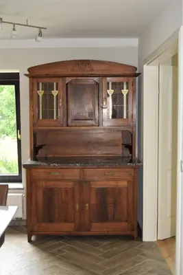 a large wooden cabinet in a room at Apartmaji Maln in Dolenjske Toplice