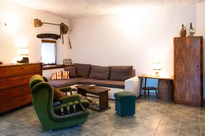 a living room with a couch and a table at Hiša Hrastovlje - Countryside House in Hrastovlje