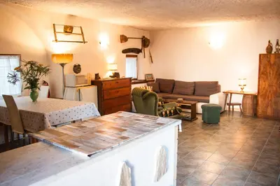 a living room with a table and a couch at Hiša Hrastovlje - Countryside House in Hrastovlje