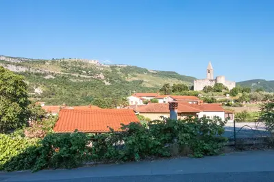 a view of a town with houses and a hill at Hiša Hrastovlje - Countryside House in Hrastovlje