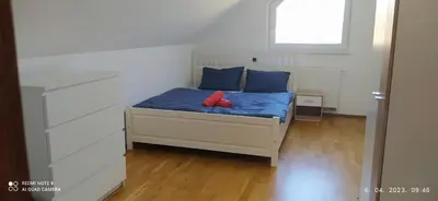 a bed with blue and red pillows on it at Villa FRIDA in Rogaška Slatina